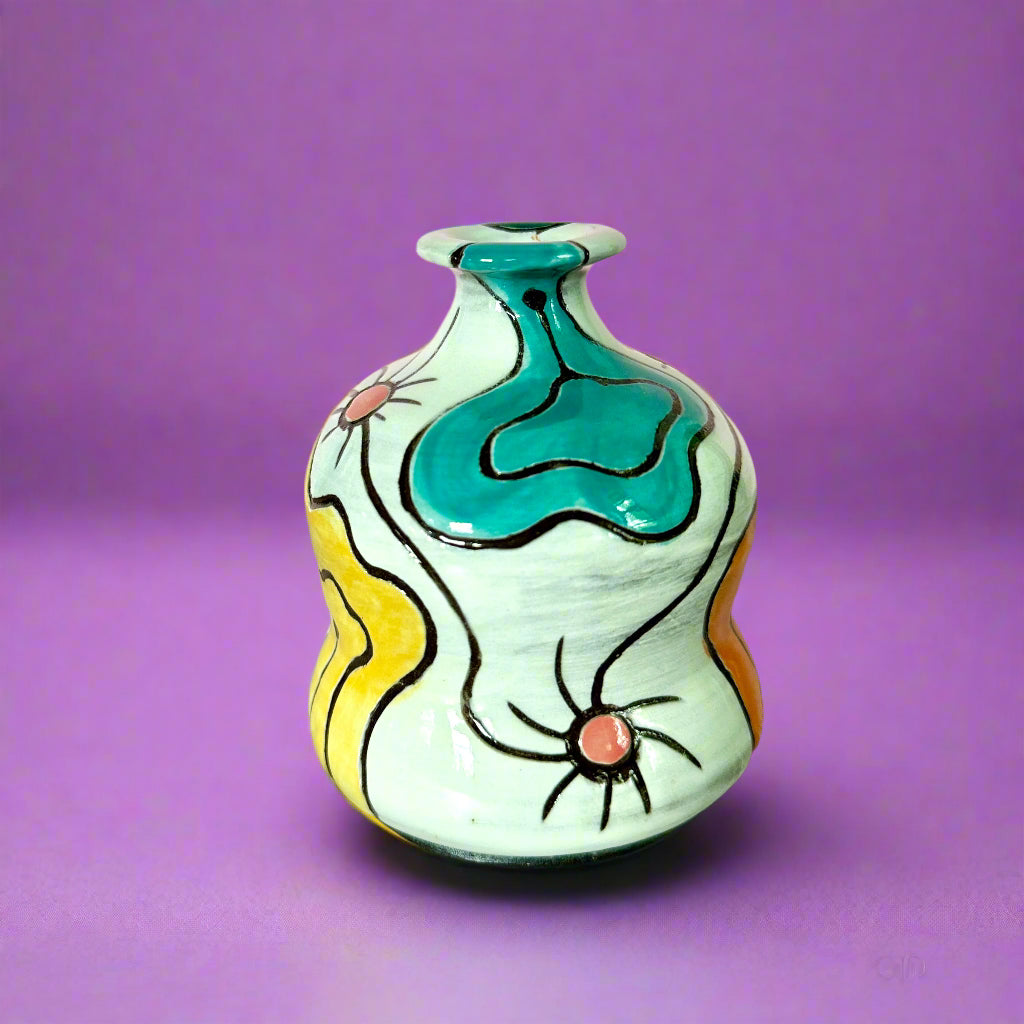 Decorative ceramic vase with abstract design on a wooden surface